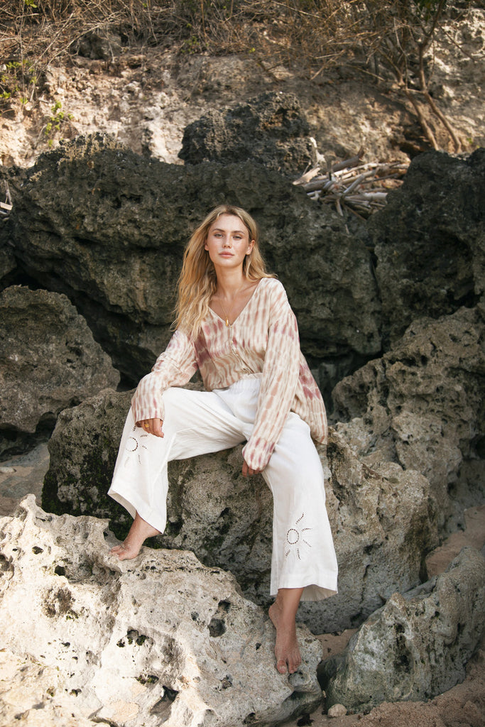 model wearing tie dye top with white linen pant