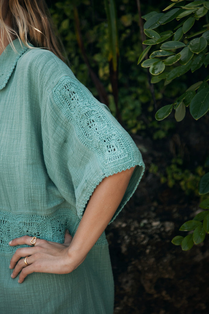 model wearing teal shirt with organic shape ring 